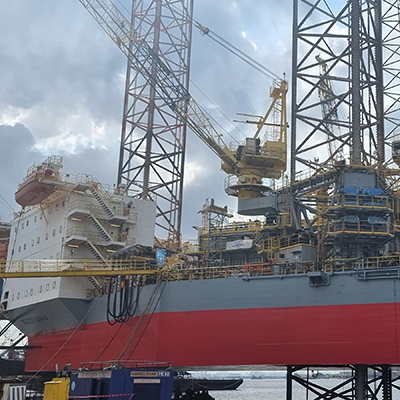 Cranes remove pieces of a Mobile Offshore Drilling Unit.